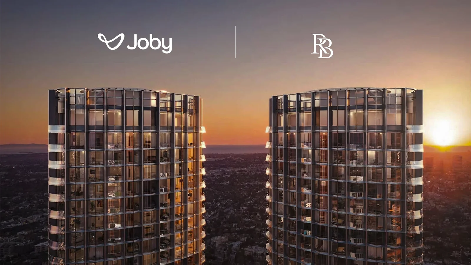 Two modern glass towers at sunset with the logos Joby (left) and a second brand (right) separated by a vertical divider, suggesting a partnership.