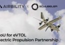 Banner with Airbility and Schubeler logos فوق a cloudy sky, featuring an electric aircraft in flight (eVTOL) and partial text about a partnership.