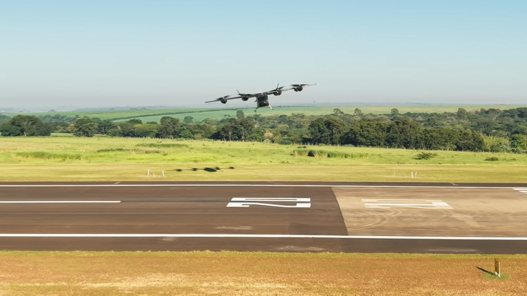 A four-engine propeller aircraft lifting off from a runway with green fields and trees in the background, under a clear blue sky.