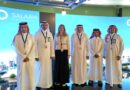 SALAAM_Roundtable - eVTOL Insights Group of six people in traditional white robes posing on a blue Salaam backdrop at an event.