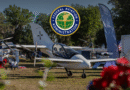 FAA emblem reading 'Federal Aviation Administration' hovering above a display of small aircraft at an outdoor airshow/aviation event.