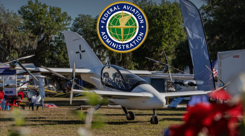 FAA emblem reading 'Federal Aviation Administration' hovering above a display of small aircraft at an outdoor airshow/aviation event.