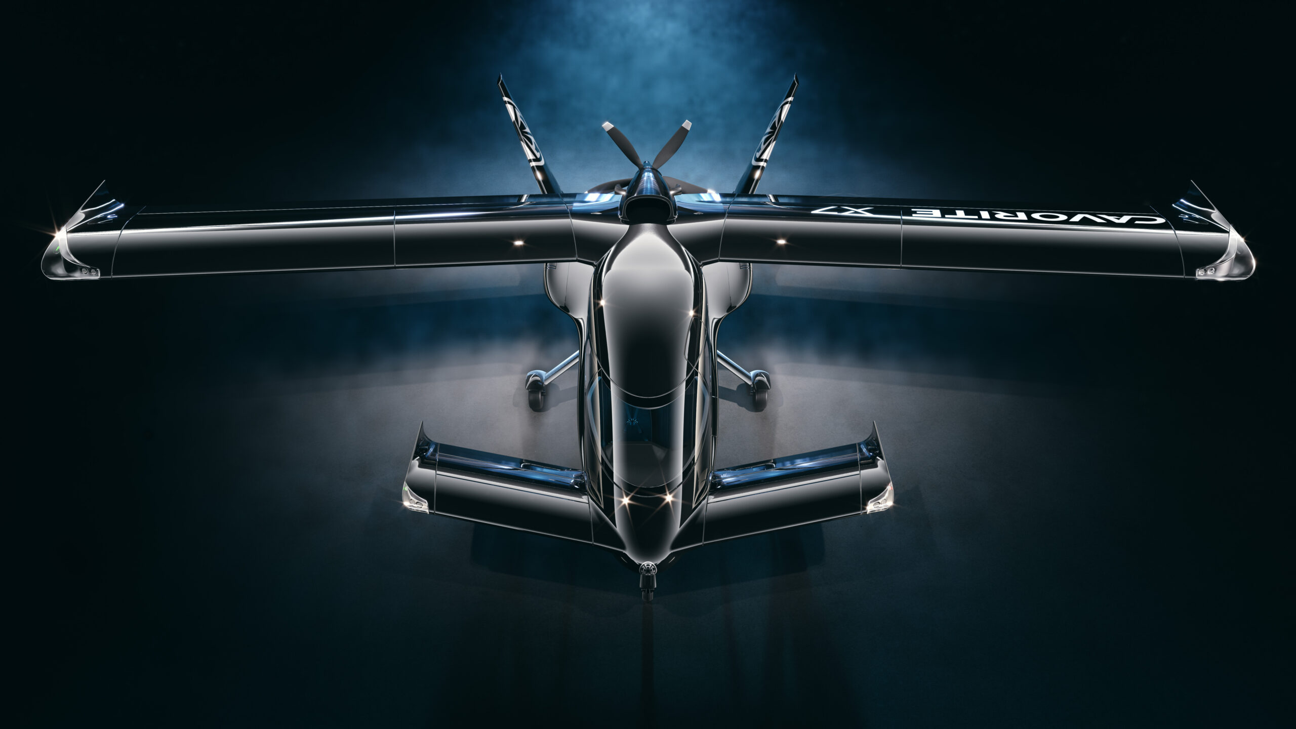 Top-down view of a high-gloss, black aircraft with wide wings and exposed rear engine nacelles against a dark background.