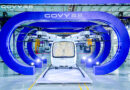 Front view of a white Govy helicopter displayed inside a large blue circular structure at an exhibition hall.