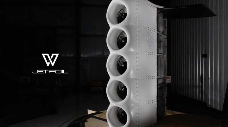 Tall vertical stack of four white turbine fans in a dim hangar, with Jetfoil logo in the lower-left.