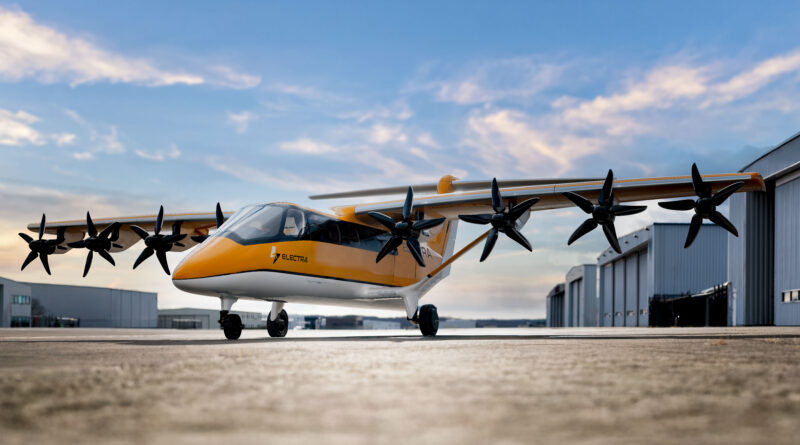 Orange and white multi-propeller aircraft parked on a tarmac beside hangars, under a blue sky.