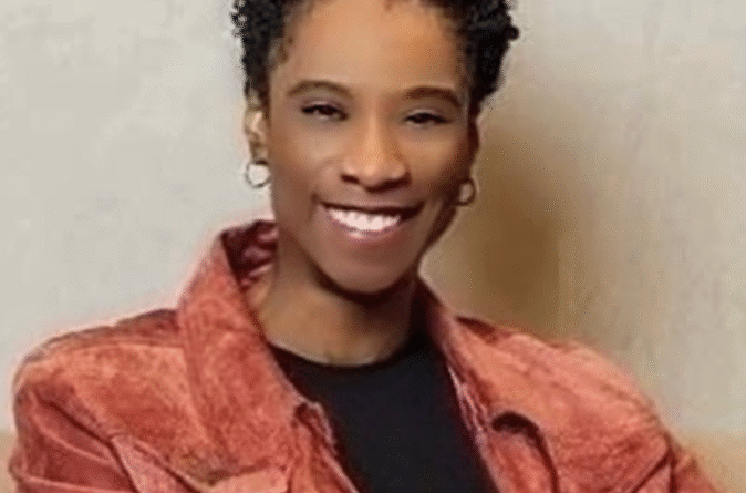 Lavera Alexander - eVTOL Insights Smiling woman with short curly hair wearing a red jacket over a black top, facing the camera.