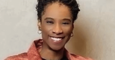 Lavera Alexander - eVTOL Insights Smiling woman with short curly hair wearing a red jacket over a black top, facing the camera.
