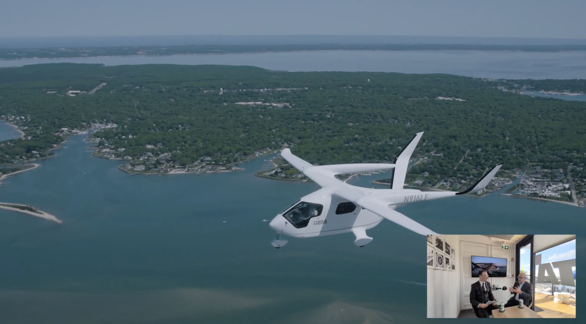 A small white airplane flying over a coastal green landscape with water channels, viewed from the aircraft; a video-call inset shows two people in a meeting room.